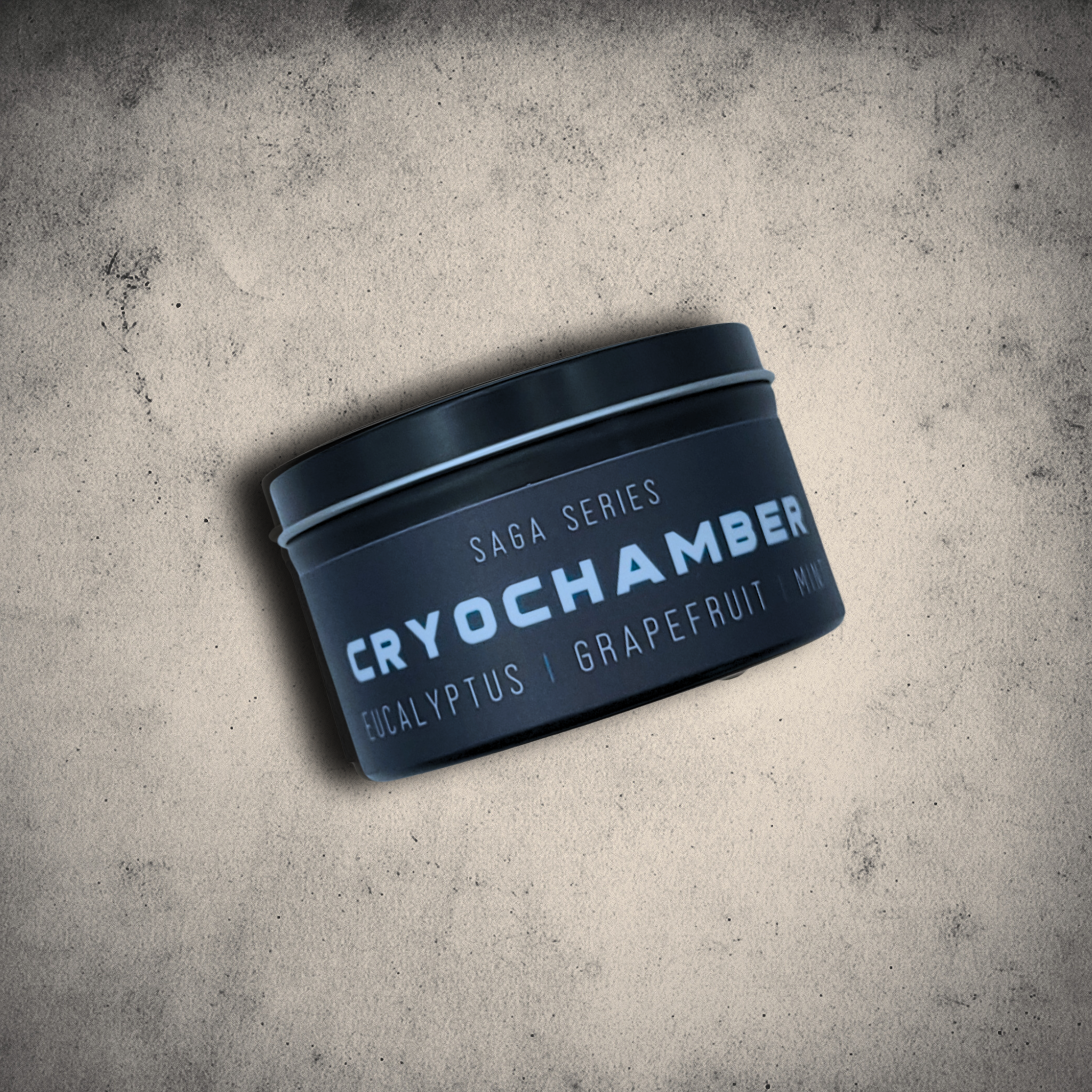 Emberlight Archives Cryochamber candle in an 8oz black tin with black label against a gray stone background, Grapefruit Mint scent.